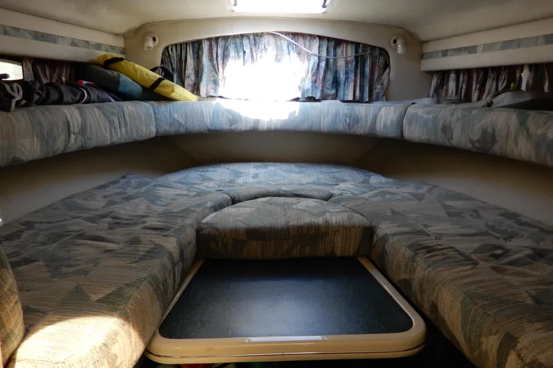 Slide: The Image of Interior cabin of a 1994 Sea Ray 310 Sun Sport boat with cushioned seating. - 22