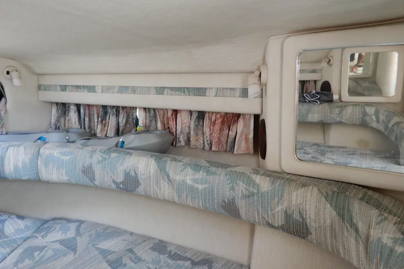 Slide: The Image of Interior cabin of 1994 Sea Ray 310 Sun Sport with patterned upholstery and mirror. - 25