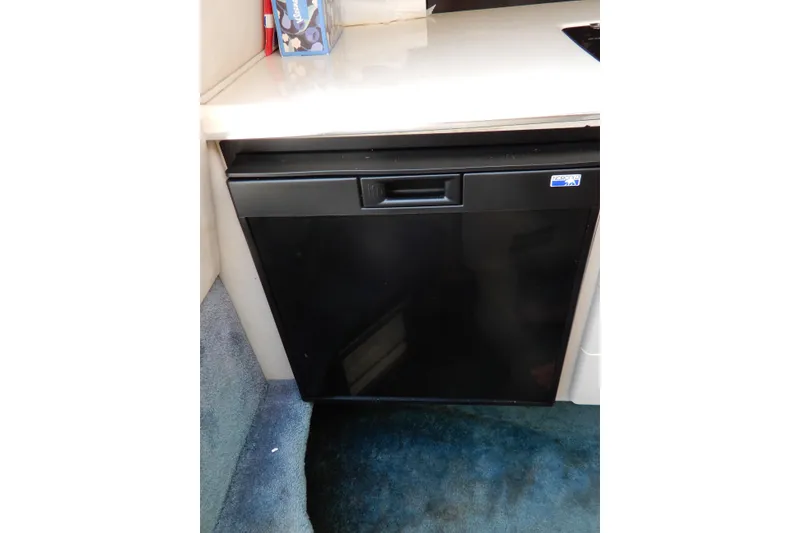 Slide: The Image of Black refrigerator inside 1994 Sea Ray 310 Sun Sport boat cabin. - 27