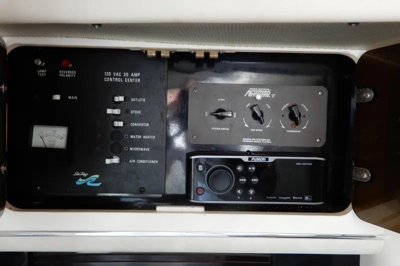 Slide: The Image of Control panel of a 1994 Sea Ray 310 Sun Sport boat with various switches and dials. - 30