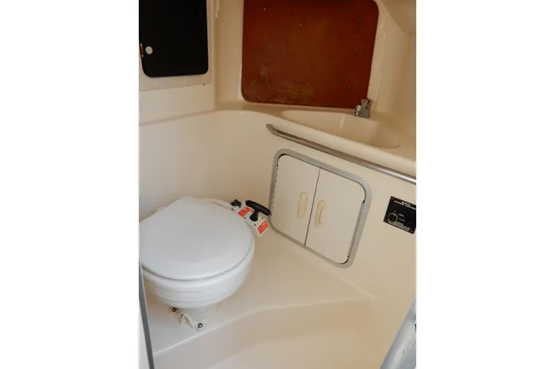 Slide: The Image of Interior of 1994 Sea Ray 310 Sun Sport boat bathroom with toilet and sink. - 31