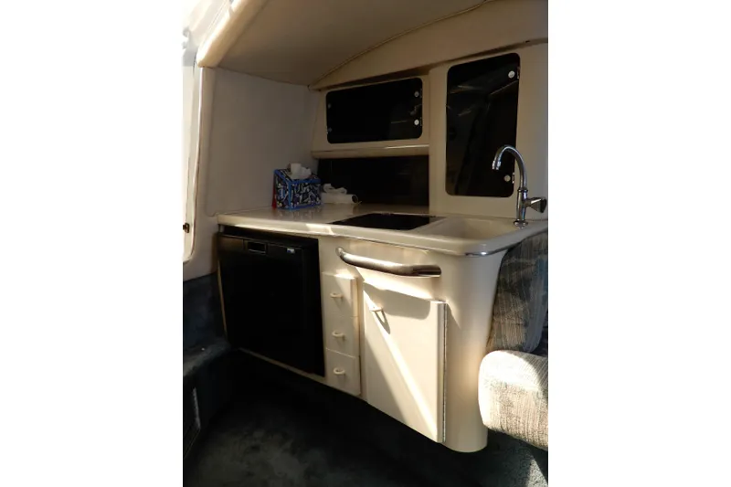 Slide: The Image of 1994 Sea Ray 310 Sun Sport cabin interior with kitchenette and sink. - 33