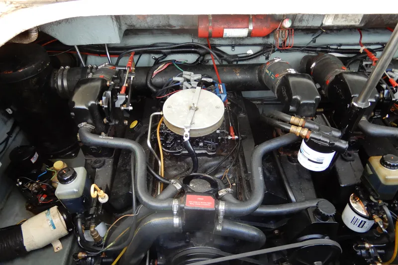 Slide: The Image of Engine compartment of a 1994 Sea Ray 310 Sun Sport boat, showcasing mechanical components. - 34