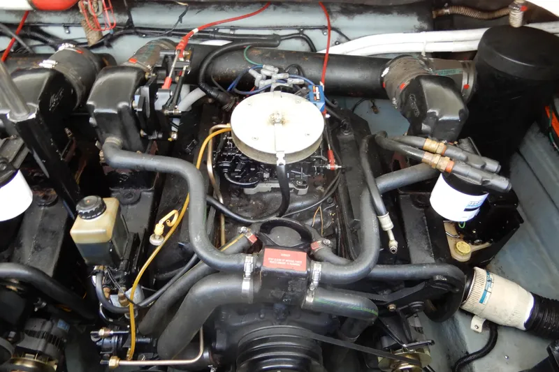 Slide: The Image of Engine compartment of a 1994 Sea Ray 310 Sun Sport boat, showcasing mechanical components. - 35