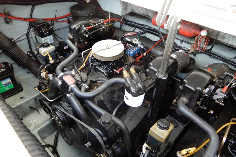 Slide: The Image of Engine compartment of a 1994 Sea Ray 310 Sun Sport boat, showcasing mechanical components. - 36
