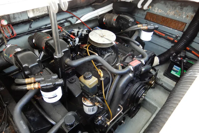 Slide: The Image of Engine compartment of a 1994 Sea Ray 310 Sun Sport boat, showcasing mechanical components. - 37