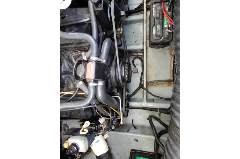 Slide: The Image of Engine compartment of a 1994 Sea Ray 310 Sun Sport boat, showing hoses and components. - 38
