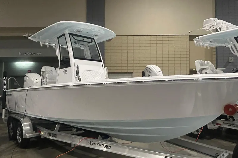 The Image of 2026 Sportsman Masters 247OE Bay Boat displayed indoors on a trailer. - 1
