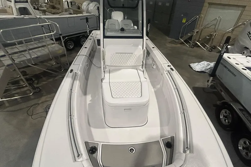 Slide: The Image of 2026 Sportsman Masters 247OE Bay Boat interior with seating and console, displayed indoors. - 4