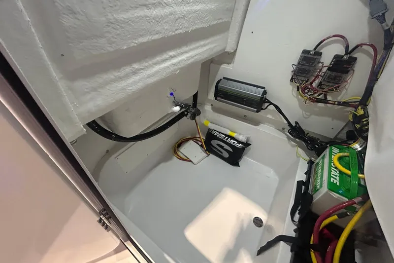 Slide: The Image of 2026 Sportsman Masters 227 Bay Boat interior wiring and battery compartment. - 4
