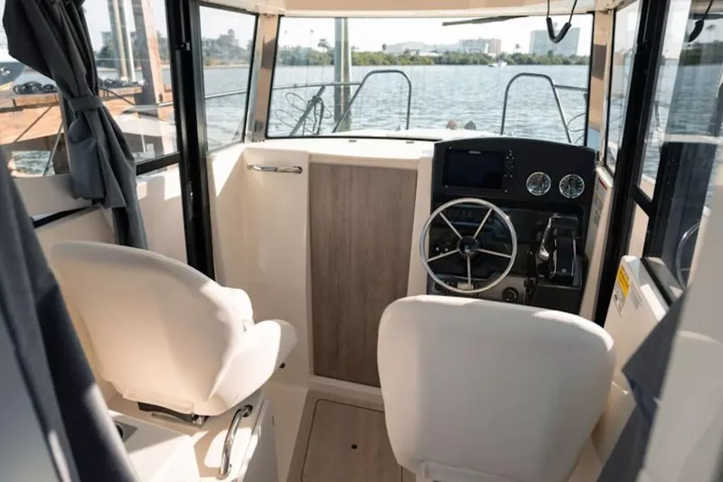 Slide: The Image of Interior of 2026 Bayliner Trophy T23 Pilothouse boat with steering wheel and controls. - 10