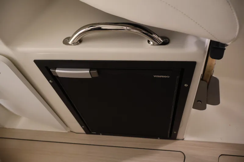 Slide: The Image of 2026 Bayliner Trophy T23 Pilothouse interior with Vitrifrigo fridge and chrome handle. - 33