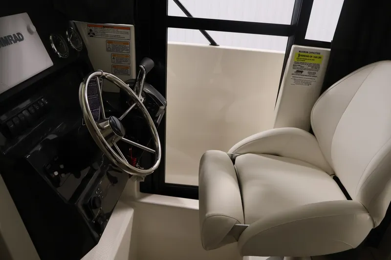 Slide: The Image of Interior of 2026 Bayliner Trophy T23 Pilothouse with steering wheel and captain's chair. - 19