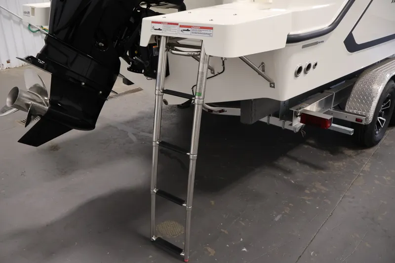 Slide: The Image of 2026 Bayliner Trophy T23 Pilothouse boat with ladder and outboard motor detail. - 55