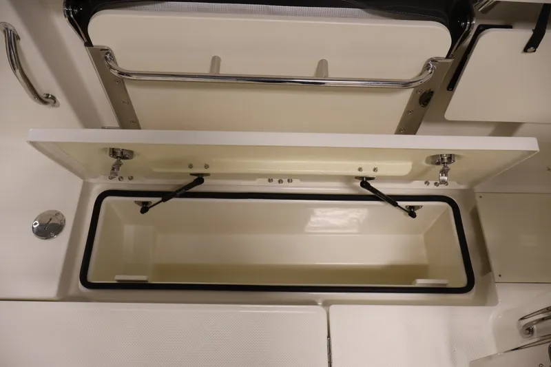 Slide: The Image of Open storage compartment in 2026 Bayliner Trophy T23 Pilothouse boat interior. - 43