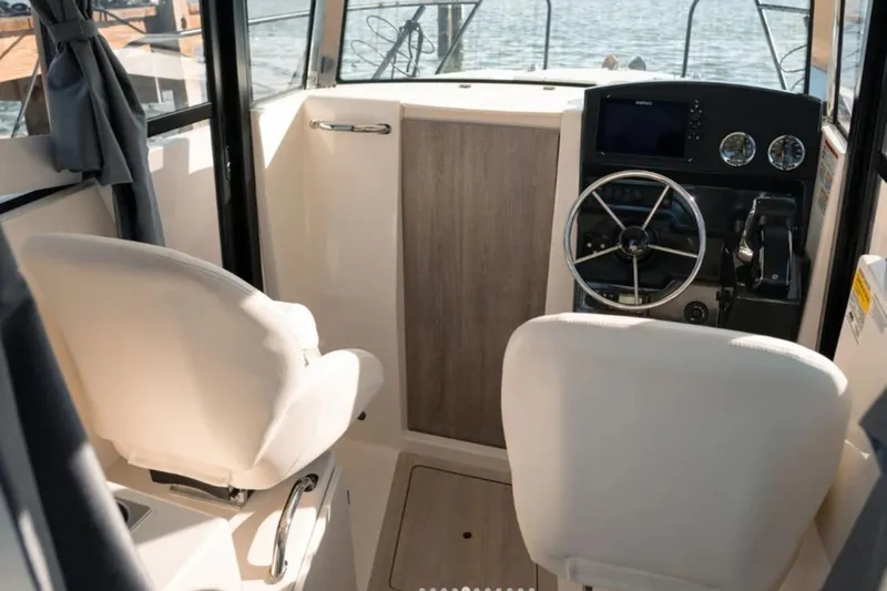 Slide: The Image of Interior of 2026 Bayliner Trophy T23 Pilothouse with steering wheel and seating. - 3