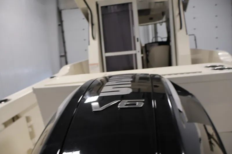 Slide: The Image of 2026 Bayliner Trophy T23 Pilothouse with V6 engine in indoor setting. - 57