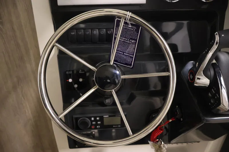 Slide: The Image of Steering wheel and controls of 2026 Bayliner Trophy T23 Pilothouse boat. - 21