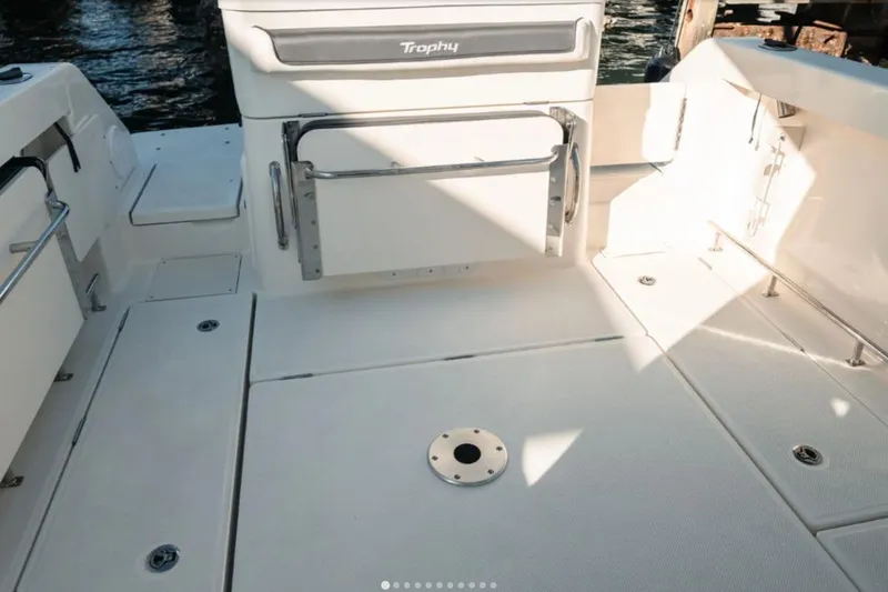 Slide: The Image of 2026 Bayliner Trophy T23 Pilothouse boat deck with seating and storage compartments. - 6