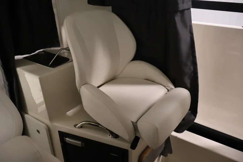 Slide: The Image of 2026 Bayliner Trophy T23 Pilothouse interior with white cushioned seat. - 31