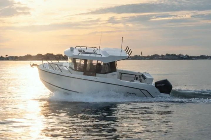 Slide: The Image of 2026 Bayliner Trophy T23 Pilothouse boat cruising at sunset on calm waters. - 7