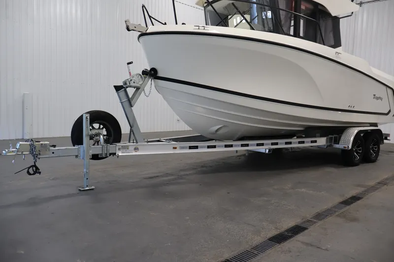 Slide: The Image of 2026 Bayliner Trophy T23 Pilothouse boat on trailer in indoor setting. - 61