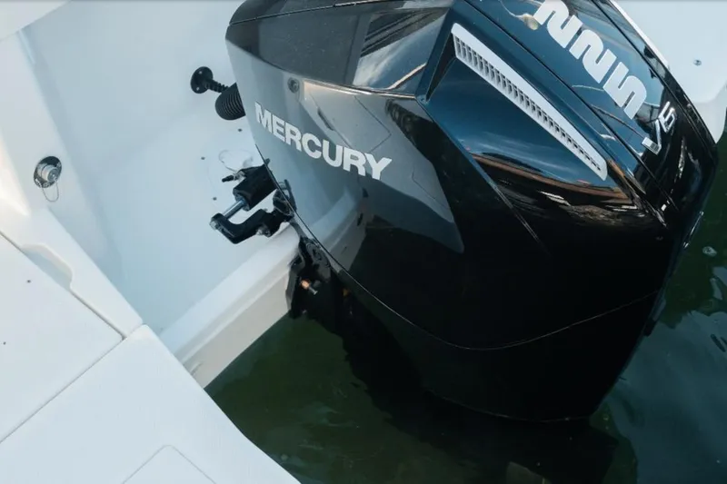 Slide: The Image of 2026 Bayliner Trophy T23 Pilothouse with Mercury outboard engine in water. - 8