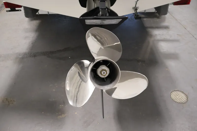 Slide: The Image of 2026 Bayliner Trophy T23 Pilothouse boat propeller in a garage setting. - 58