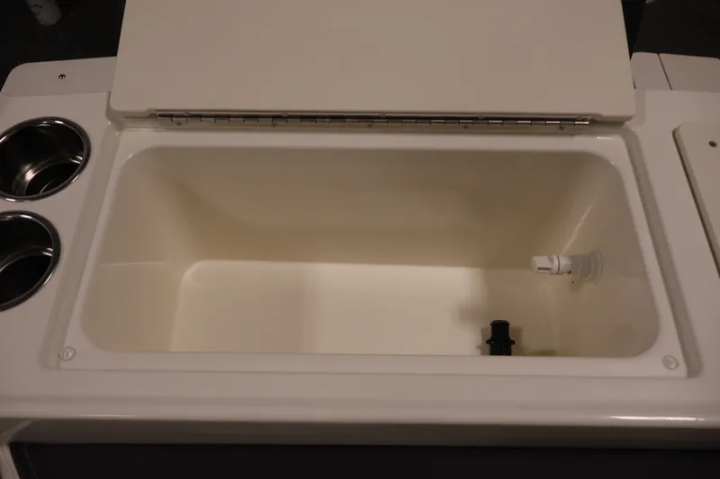 Slide: The Image of 2026 Bayliner Trophy T23 Pilothouse livewell with cup holders and drainage system. - 50