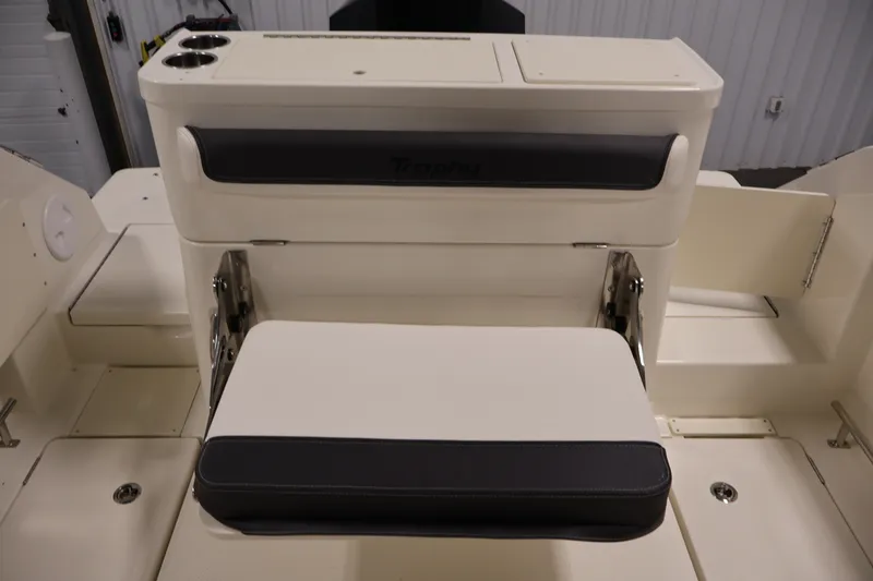 Slide: The Image of 2026 Bayliner Trophy T23 Pilothouse interior seating with cup holders and storage compartments. - 48