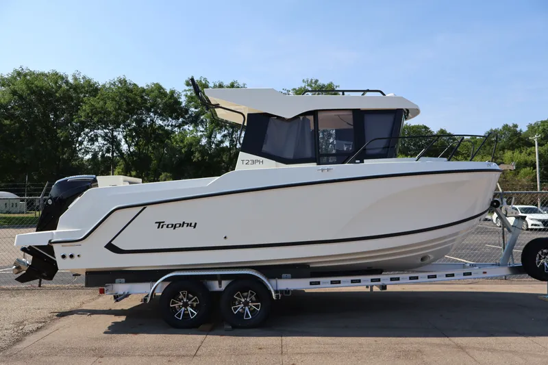 Slide: The Image of 2026 Bayliner Trophy T23 Pilothouse boat on trailer, side view. - 64