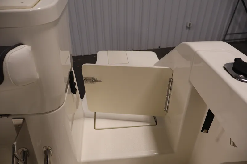 Slide: The Image of 2026 Bayliner Trophy T23 Pilothouse interior with open storage compartment. - 51