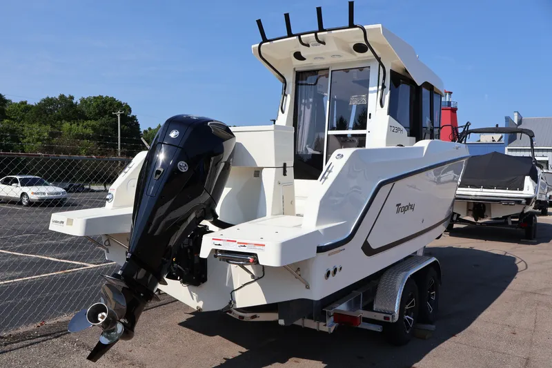 Slide: The Image of 2026 Bayliner Trophy T23 Pilothouse boat with outboard motor on trailer. - 65