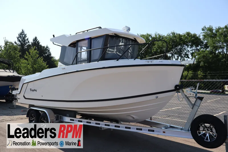 Slide: The Image of 2026 Bayliner Trophy T23 Pilothouse boat on trailer, displayed outdoors. - 63