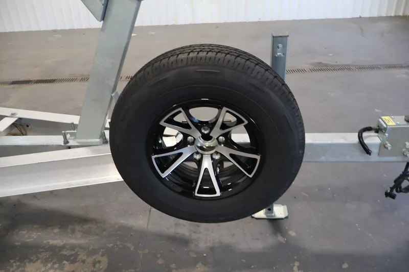Slide: The Image of Trailer wheel for 2026 Bayliner Trophy T23 Pilothouse, featuring sleek black and silver design. - 60