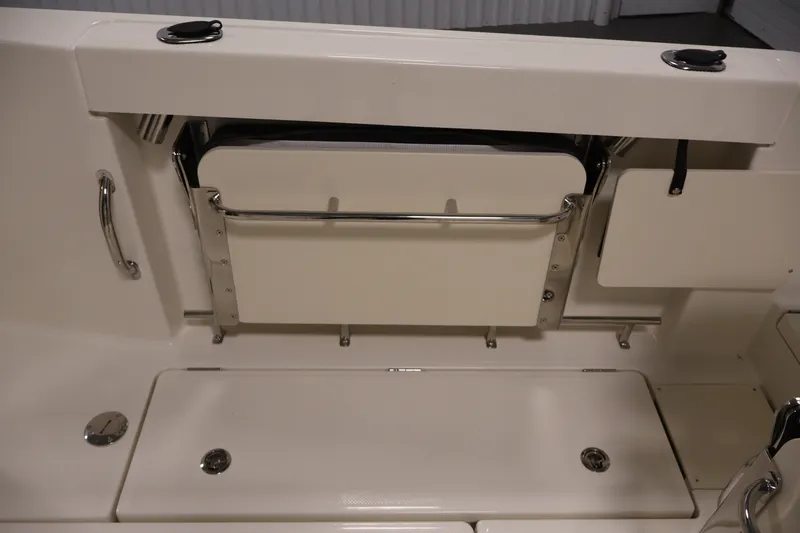 Slide: The Image of 2026 Bayliner Trophy T23 Pilothouse interior with foldable seating and storage compartments. - 41