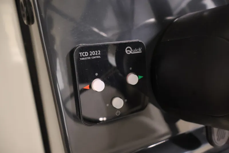 Slide: The Image of Bayliner Trophy T23 Pilothouse 2026 thruster control panel, featuring Quick TCD 2022 system. - 25