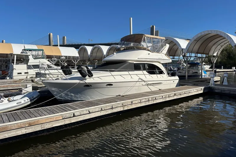 The Image of 2003 Meridian 381 Sedan yacht docked at marina under clear blue sky. - 0