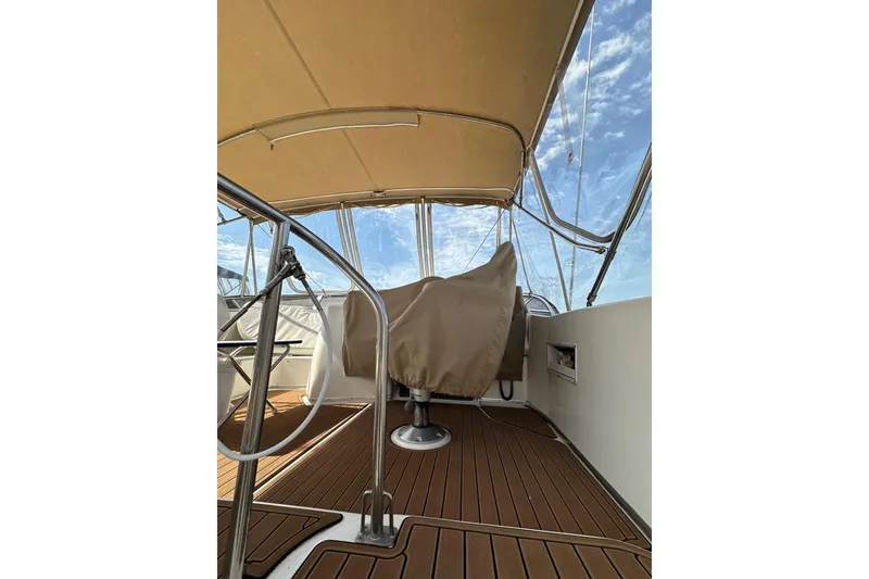 Slide: The Image of Covered deck area of a 2003 Meridian 381 Sedan boat under a clear sky. - 10