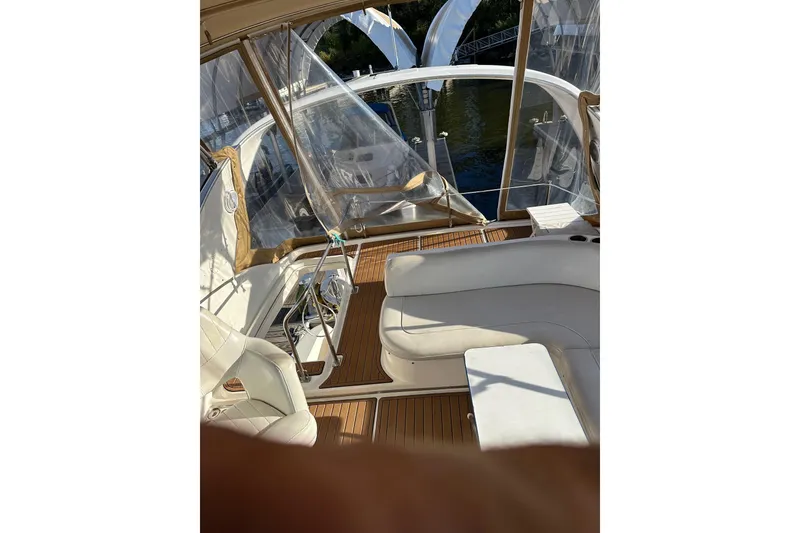 Slide: The Image of Interior view of a 2003 Meridian 381 Sedan yacht with white seating and wooden flooring. - 12