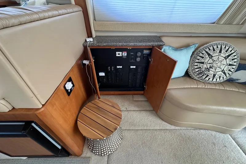 Slide: The Image of Electrical panel inside 2003 Meridian 381 Sedan yacht, featuring wooden cabinetry and nautical decor. - 16