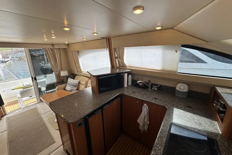 Slide: The Image of Luxurious interior of a 2003 Meridian 381 Sedan yacht with modern kitchen and seating area. - 18