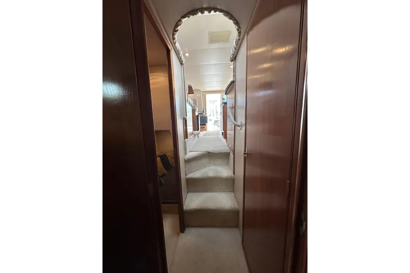 Slide: The Image of Interior hallway of 2003 Meridian 381 Sedan yacht with carpeted stairs and wooden paneling. - 19