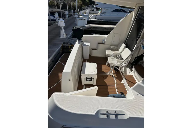 Slide: The Image of 2003 Meridian 381 Sedan boat interior with seating and deck view at marina. - 2