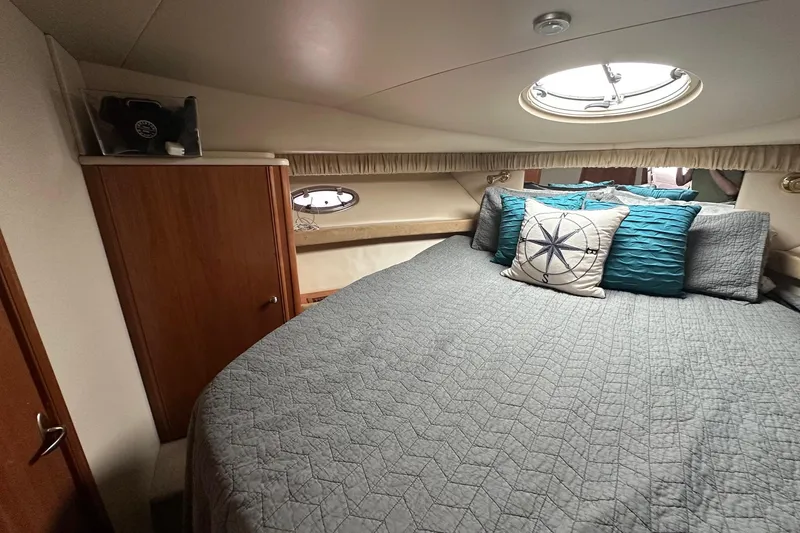 Slide: The Image of Luxurious cabin interior of 2003 Meridian 381 Sedan yacht with cozy bedding and nautical decor. - 20