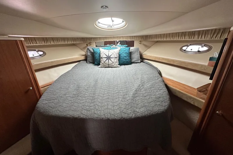 Slide: The Image of Cozy bedroom in 2003 Meridian 381 Sedan yacht with portholes and decorative pillows. - 21
