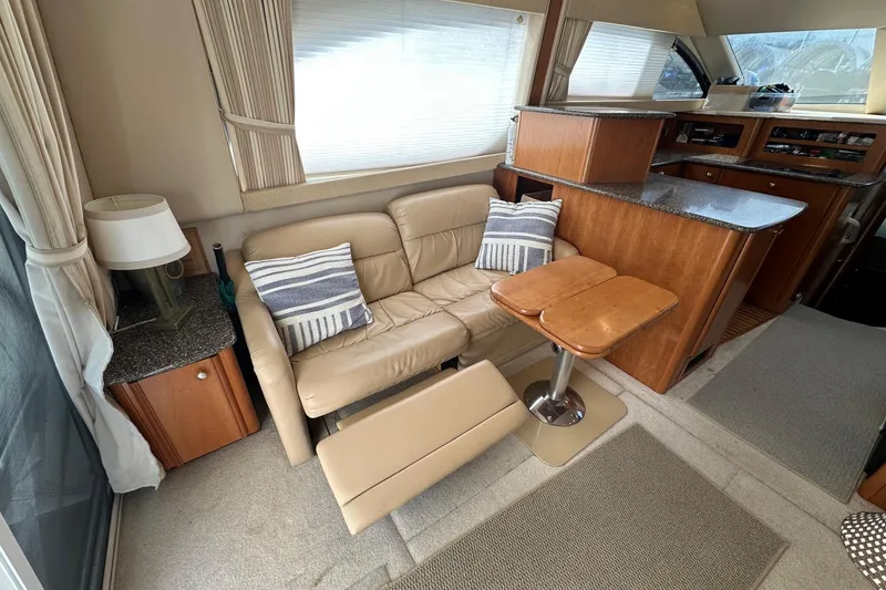 Slide: The Image of Interior of 2003 Meridian 381 Sedan yacht with cozy seating and wooden cabinetry. - 24