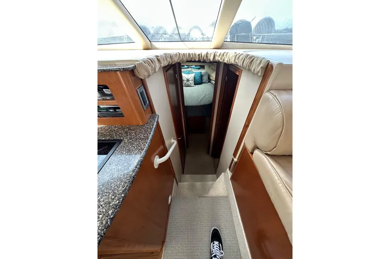 Slide: The Image of Interior view of a 2003 Meridian 381 Sedan yacht, featuring a cozy cabin entrance. - 27