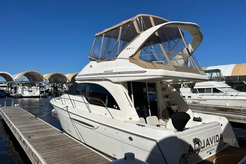 Slide: The Image of 2003 Meridian 381 Sedan yacht docked at marina under clear blue sky. - 3