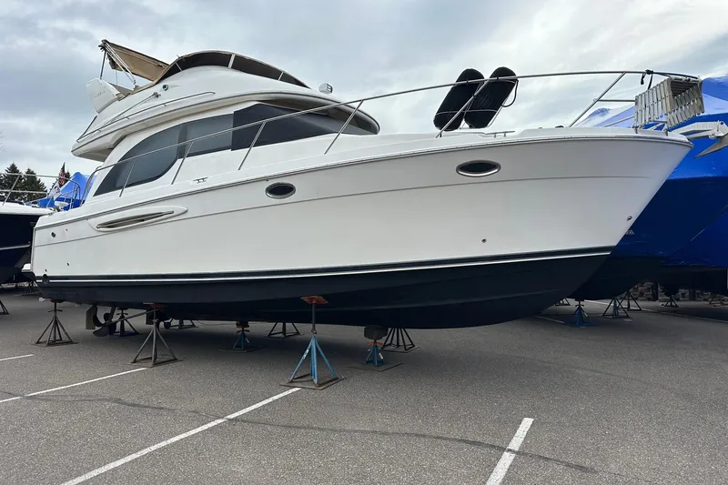 Slide: The Image of 2003 Meridian 381 Sedan yacht on stands in a parking lot, side view. - 7